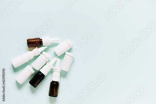 Set of different white and brown medicine bottles  pill bottles without label design  copy space on blue background 