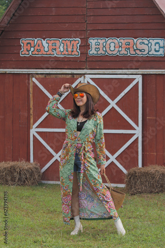 Attractive Asian woman standing with wooden house