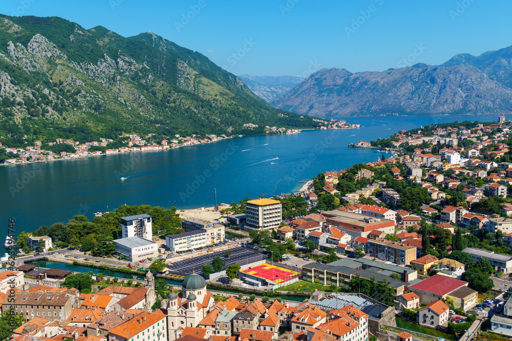 view of the Kotor city in Montenegro and the coast of the Bay of Kotor, the sea and medieval European architecture, red tiled roofs, the concept of traveling across the Balkans