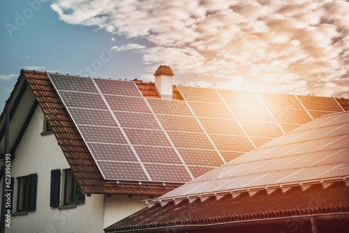 Harvesting the Sun. Sustainable Power Generation with a Solar Photovoltaic Systems on a Countryside House. Sun-produced energy. Semiconductor technology. Carbonless footprint. photo