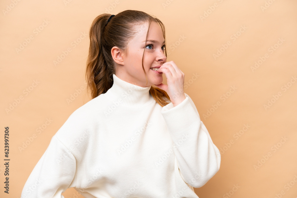 Young caucasian woman isolated on beige background is a little bit nervous Young caucasian woman isolated on beige background is a little bit nervous