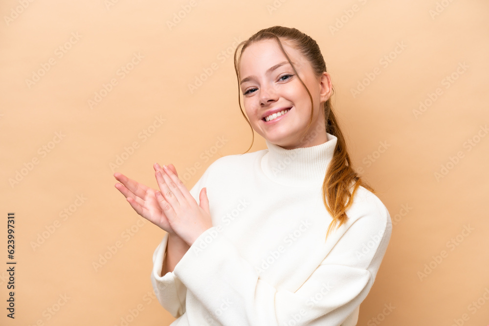 Young caucasian woman isolated on beige background applauding Young caucasian woman isolated on beige background applauding