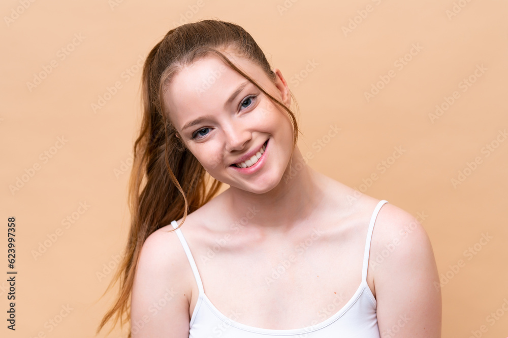 Young caucasian girl isolated on beige background with happy expression. Close up portrait Young caucasian girl isolated on beige background with happy expression. Close up portrait