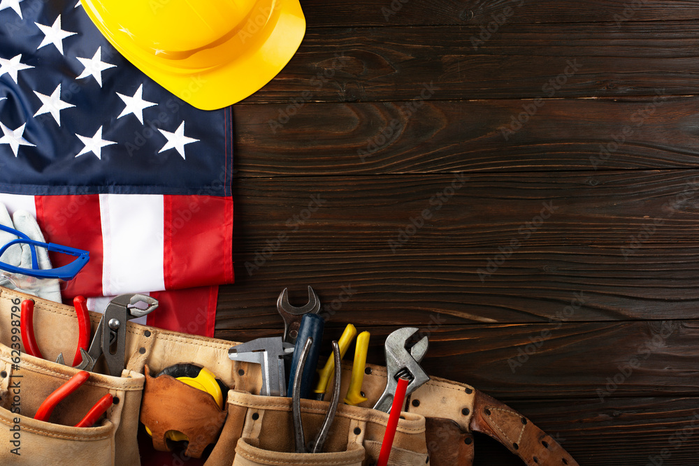 Tools hardhat toolbelt and us flag on wooden background labor day banner mockup