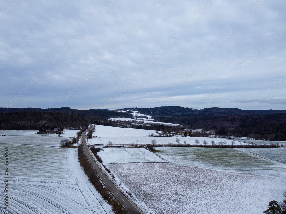 Drone shot of snowy agricultural snowy fields in Bavaria on a cloudy day Drone shot of snowy agricultural snowy fields in Bavaria on a cloudy day