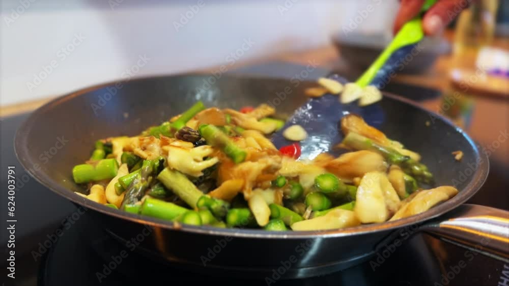 Stir fried vegetables. Asparagus. Frying asparagus in a pan. Stir fried vegetables. Asparagus. Frying asparagus in a pan.