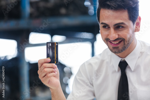 Slika na platnu Male customers paying by credit card at counter in auto parts stores