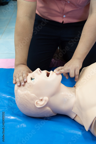 First aid CPR - clear airway training with head tilt chin lift technique. photo