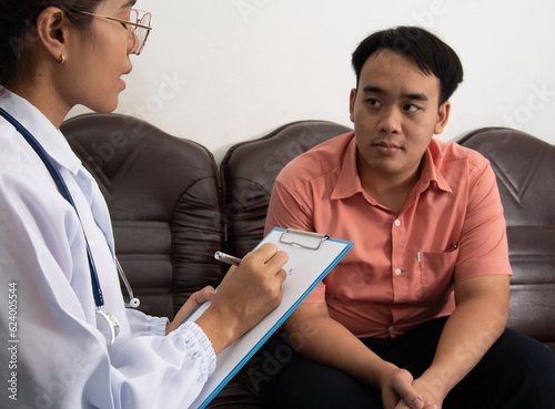 The smart doctor took a history of illness. The medicine doctor writing a medical prescription order some treatment for patient in the hospital.
