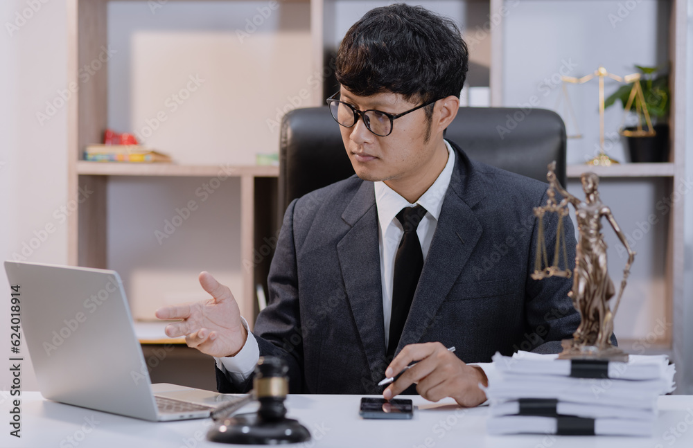 Asian lawyer working with contract at desk, justice and law concept. Asian lawyer working with contract at desk, justice and law concept.