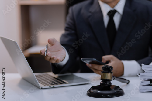 Asian lawyer working with contract at desk, justice and law concept.