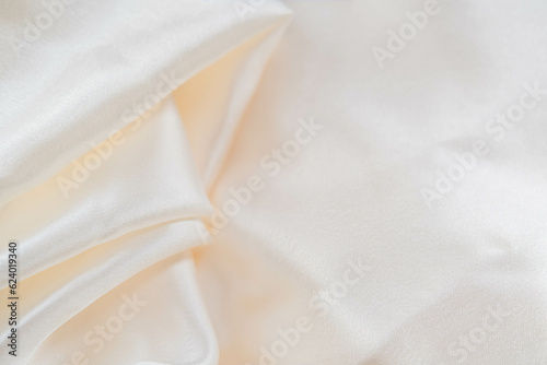 Abstract background of luxury fabric, folded textile or liquid wave or wavy folds silk texture satin material