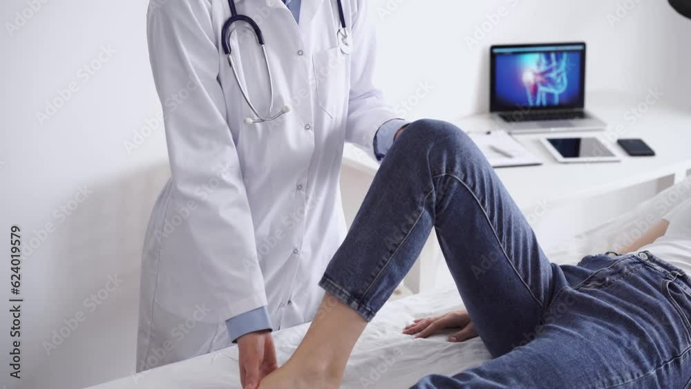Doctor and patient are at the usual medical inspection in the clinic. Therapist examines a young woman's knee. Medicine concept Doctor and patient are at the usual medical inspection in the clinic. Therapist examines a young woman's knee. Medicine concept