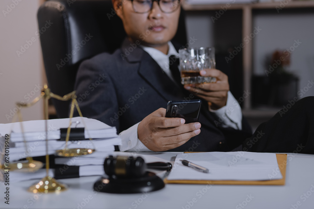 Law holding a glass of whiskey at desk, justice and law, attorney, court judge, concept. Law holding a glass of whiskey at desk, justice and law, attorney, court judge, concept.
