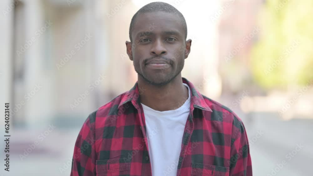 Outdoor Portrait of Serious Young African Man Outdoor Portrait of Serious Young African Man
