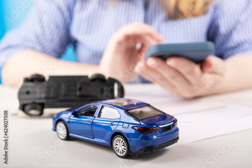 car insurance online, a woman draws up an insurance policy for a vehicle by phone on the Internet on the website of an insurance company