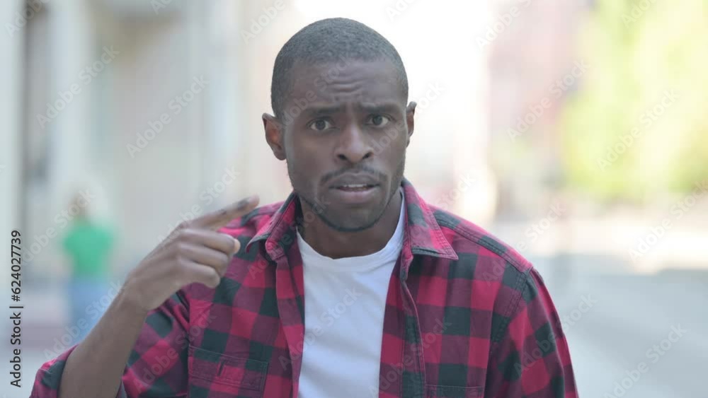 Outdoor Portrait of Upset Young African Man Doing Video Chat Outdoor Portrait of Upset Young African Man Doing Video Chat