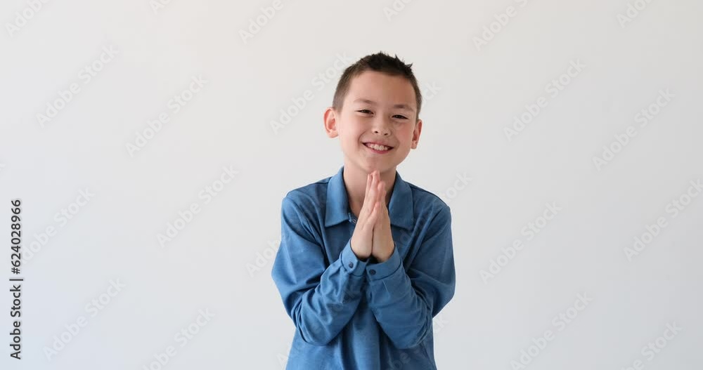 Charming Asian boy radiates happiness while applauding on a pristine white background. With a beaming smile that lights up his face, he claps his hands together in a rhythmic and spirited manner. Charming Asian boy radiates happiness while applauding on a pristine white background. With a beaming smile that lights up his face, he claps his hands together in a rhythmic and spirited manner.
