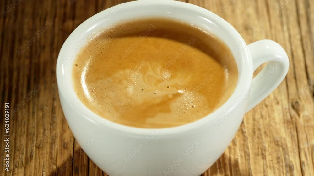 Super slow motion of falling drop into coffee with camera motion. Filmed on high speed cinema camera, 1000fps placed on high speed cine bot. Super slow motion of falling drop into coffee with camera motion. Filmed on high speed cinema camera, 1000fps placed on high speed cine bot.