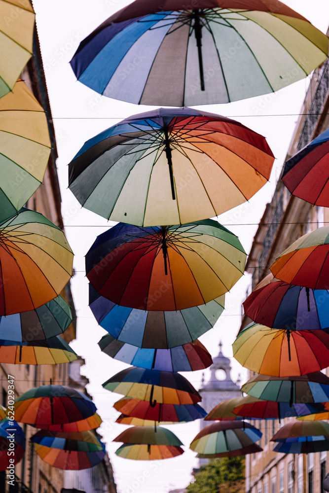 colourful umbrellas background on pink street in Lisbon Portugal 