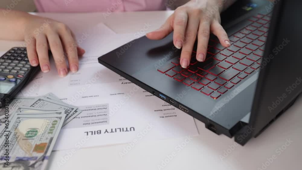 Calculator and utility bill, Energy bill showing electricity and gas usage, water and heating invoice, woman at home counting utility bills on a calculator Calculator and utility bill, Energy bill showing electricity and gas usage, water and heating invoice, woman at home counting utility bills on a calculator