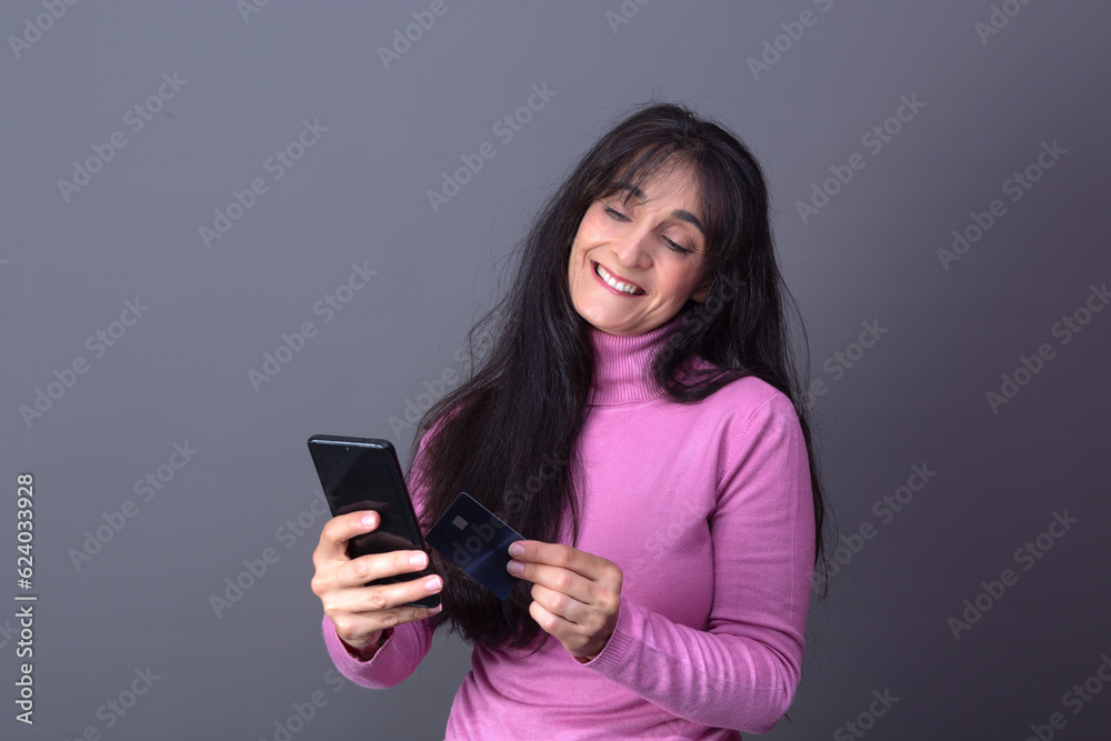 elegant woman in turtleneck sweater, buying with card and mobile elegant woman in turtleneck sweater, buying with card and mobile