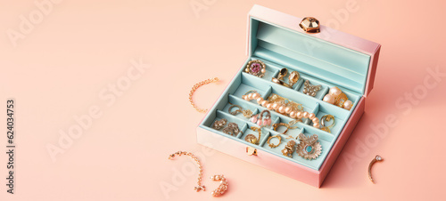Jewelry in costume jewelry storage case isolated on pastel flat background with copy space. Creative blue pink banner template for jewelry store. Generative AI.
