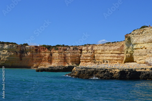 Yellow rocks near the sea in Faro city Portugal