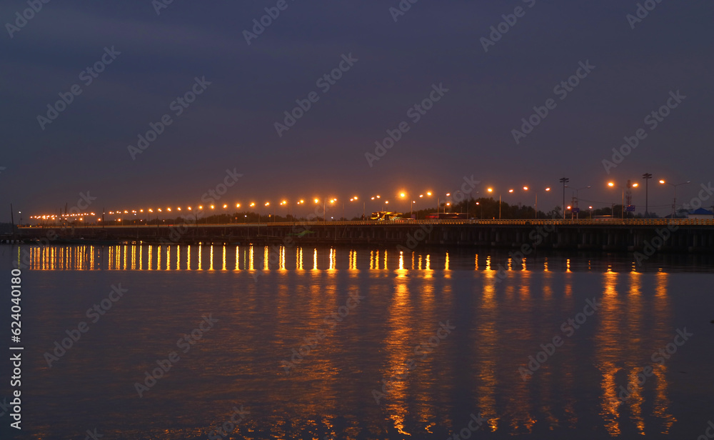 Bridge with Lighting Reflections on the Sea at Night