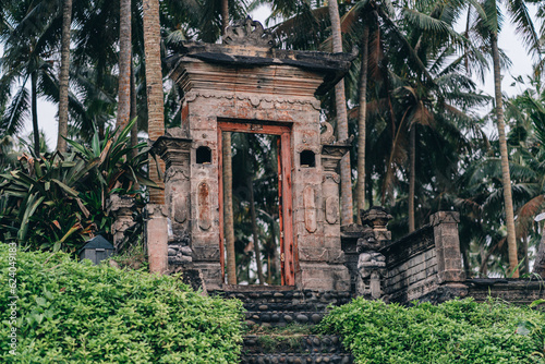 Stone temple gates in tropical jungle. Ancient ruins surrounded with exotic palms trees