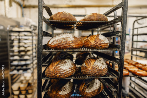 Freshly baked sourdough loaves on a baker's trolley