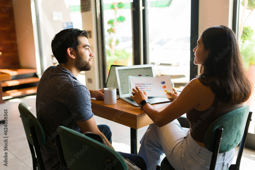 Cheerful remote workers working together in the coffee shop Cheerful remote workers working together in the coffee shop