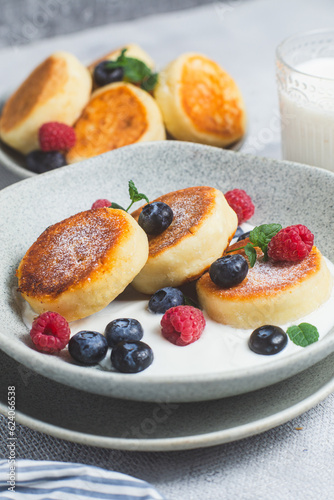 Cottage cheese pancakes with creamy sauce  raspberries and blueberries