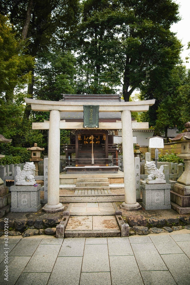 Japanese Torii gate in Kyoto. Traditional shrine gate near temples in a forest in Japan Japanese Torii gate in Kyoto. Traditional shrine gate near temples in a forest in Japan