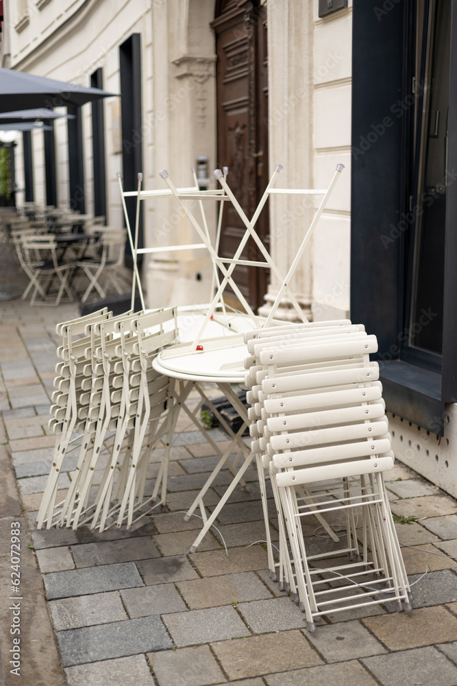 Chairs and tables stacked in a closed cafe