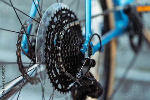 Closeup, selective focus, cogwheel with bicycle wheel chain. Important detail. Concept of repair photo