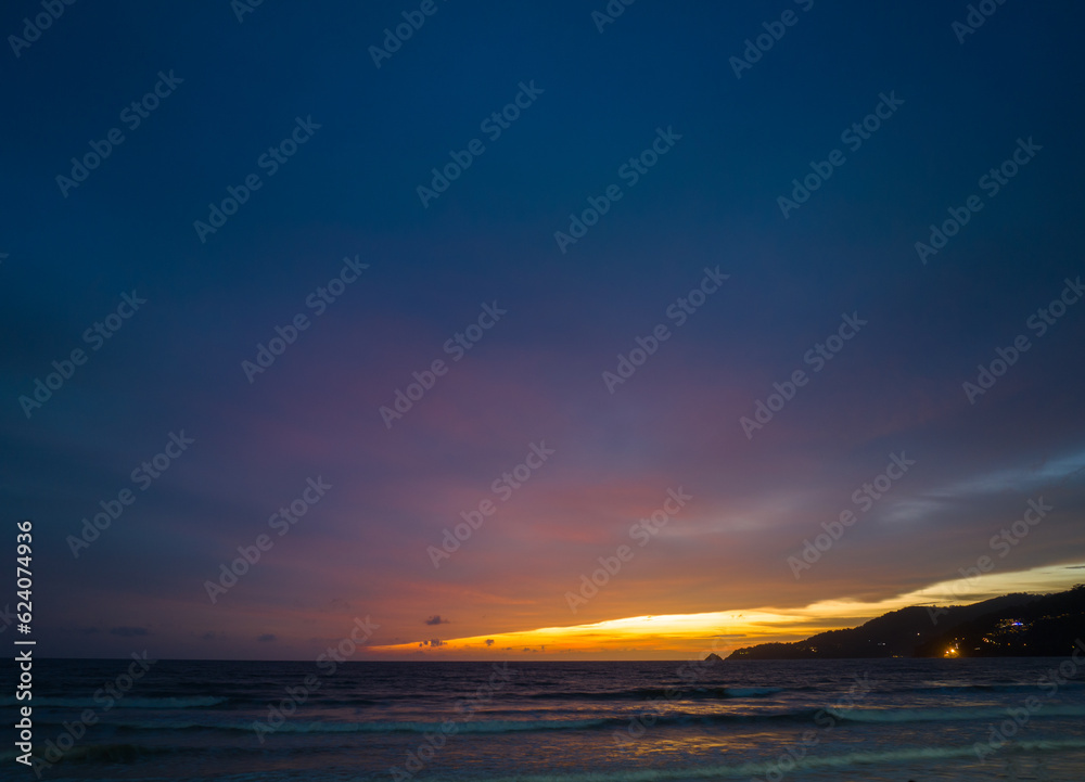 Fototapeta premium The sky changes color from yellow to red as the sun sets over the sea..sunset landscape amazing light of nature cloudscape sky. .Big sun and red lighting sky background. 4k resolution