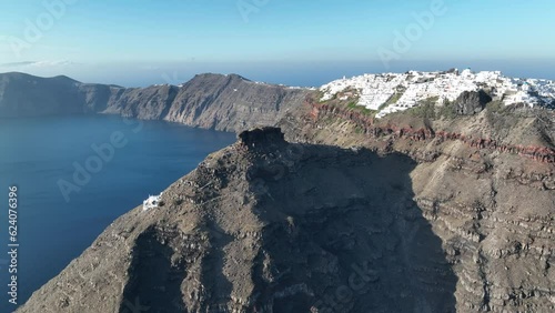 Cinematic 4k aerial video of Skaros rock on the edge of the caldera cliff on Santorini, Greece photo