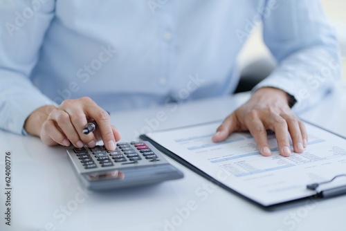 Businesswoman Accountant analyzing investment charts Invoice and pressing calculator buttons over documents. Accounting Bookkeeper Clerk  Bank Advisor And Auditor