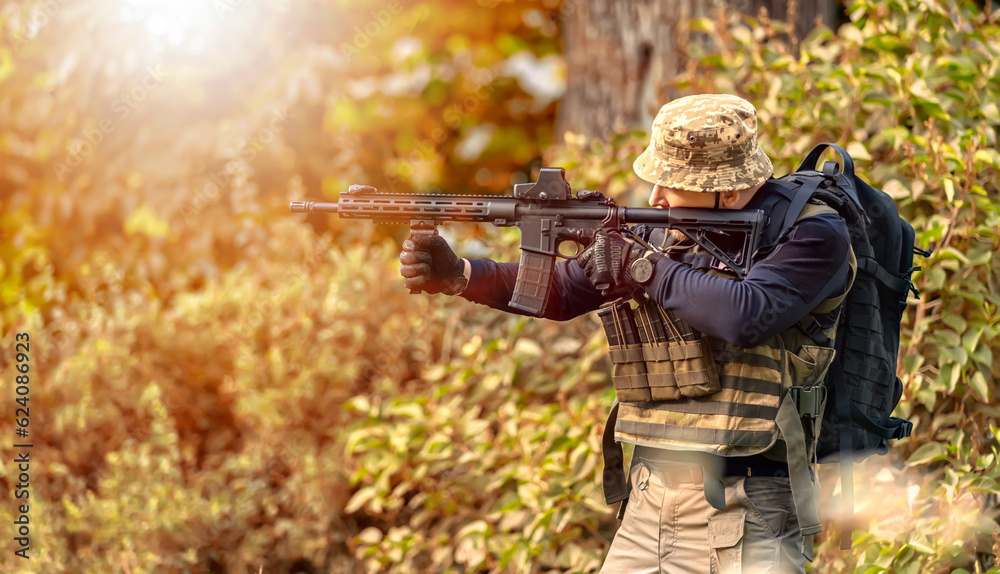 Warrior looks into the scope of a rifle