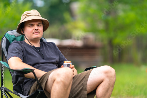 Young man relaxing while sitting in a chair outdoors