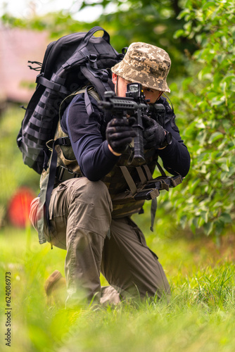 Vertical image of a soldier looking through the scope