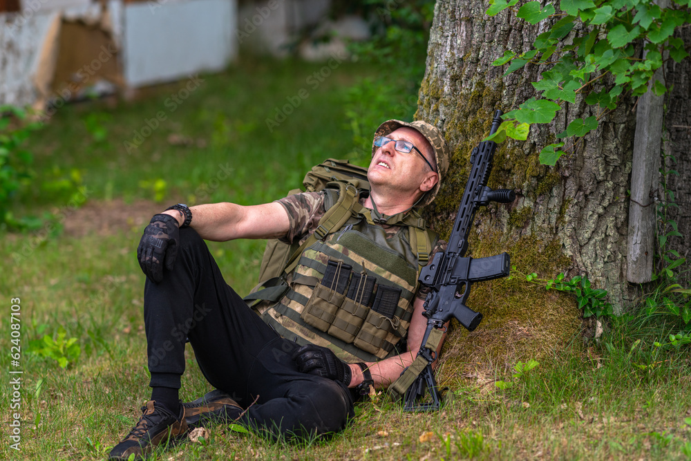 Lightly armed fighter resting under a tree
