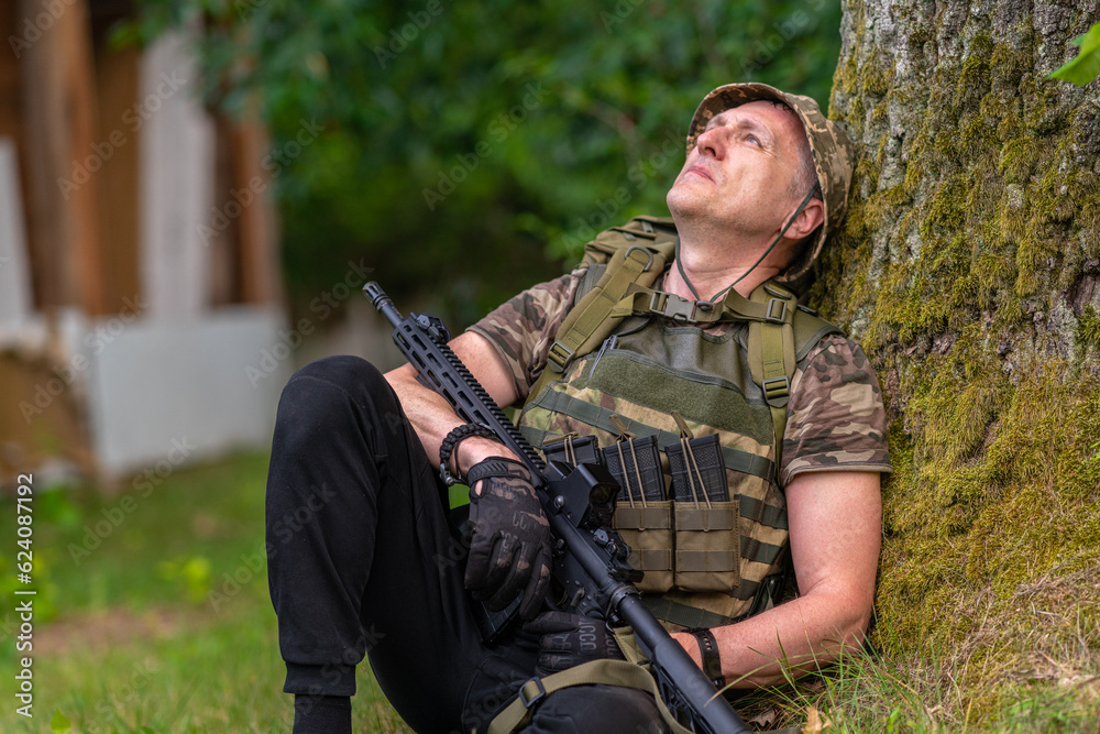 A man in military uniform looks into the distance thoughtfully