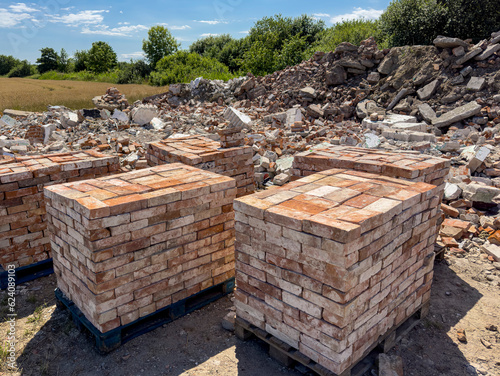 Recycling of old red bricks. Concrete debris and bricks piled ready to sell