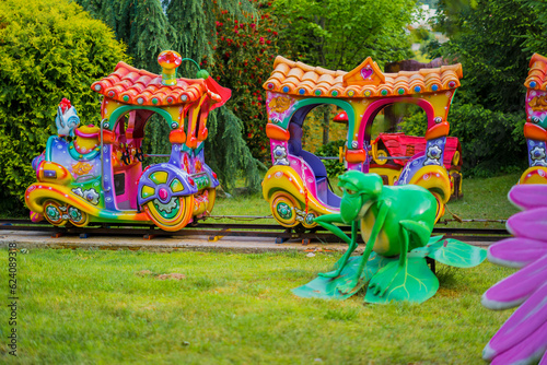 Colorful children's magic train in a farm-themed amusement park