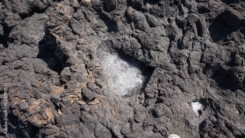 Ponta da salina Cape Verde. Close up of a natural salt pan with salt and vulcanic basalt rock.