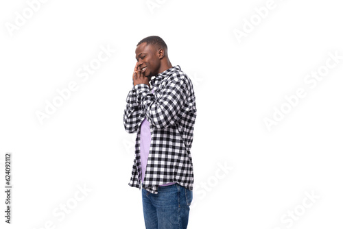modest shy young american guy with short haircut dressed casually on white background with copy space © Ivan Traimak