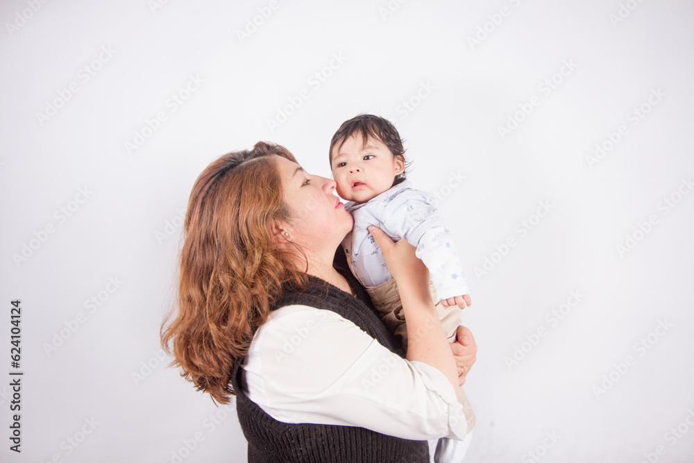 Beautiful photo of loving mom with baby on light photo studio background. Family and baby concept. Beautiful photo of loving mom with baby on light photo studio background. Family and baby concept.