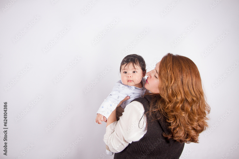 Beautiful photo of loving mom with baby on light photo studio background. Family and baby concept. Beautiful photo of loving mom with baby on light photo studio background. Family and baby concept.